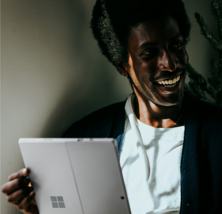 Photo of a man in a room using a tablet computer